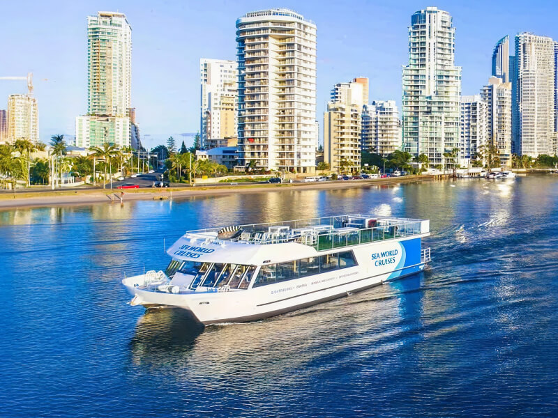 Sea World Cruises boat sailing along the Gold Coast waterways with high-rise buildings in the background.