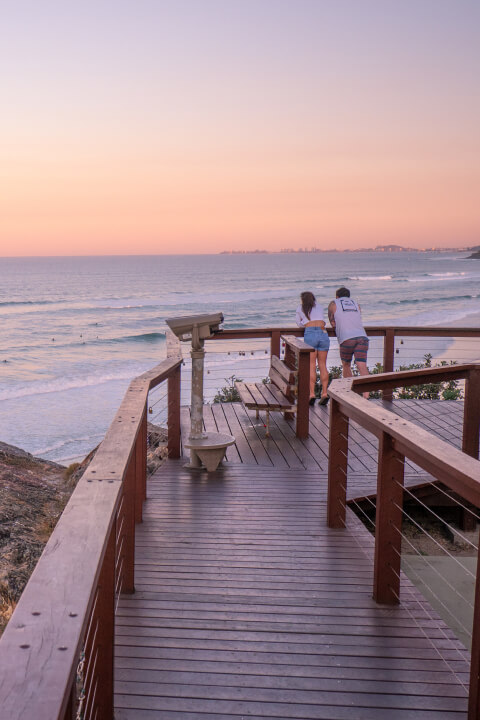 Wooden walk path with railing on the ocean shore in Broadbeach.