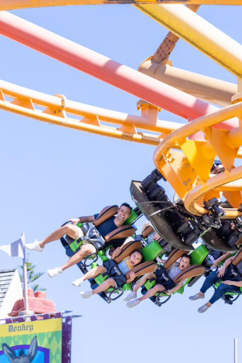 People in the air on the roller coaster at dreamworld on Gold Coast.