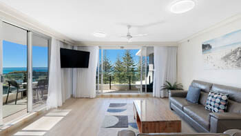 Bright beachfront living room with ocean-view balcony at ULTIQA Beach Haven on Broadbeach.