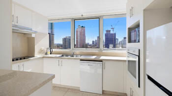 Open plan dining and living space with oceanfront balcony at ULTIQA Beach Haven on Broadbeach.