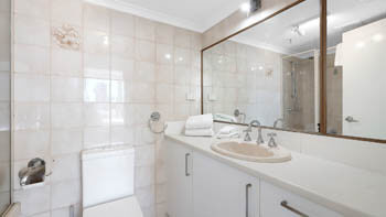 Contemporary bathroom with shower and vanity at ULTIQA Beach Haven on Broadbeach.