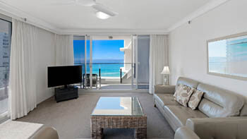 Light-filled living area with ocean-view balcony at ULTIQA Beach Haven on Broadbeach.