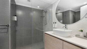 Modern bathroom with walk-in shower and vanity at ULTIQA Beach Haven on Broadbeach.