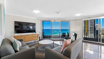 Spacious living area with oceanfront balcony views at ULTIQA Beach Haven on Broadbeach.