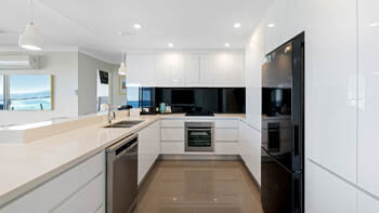 Contemporary fully equipped kitchen with sleek cabinetry at ULTIQA Beach Haven on Broadbeach.
