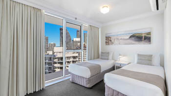 Spacious second bedroom with two single bed and air con at ULTIQA Beach Haven on Broadbeach.