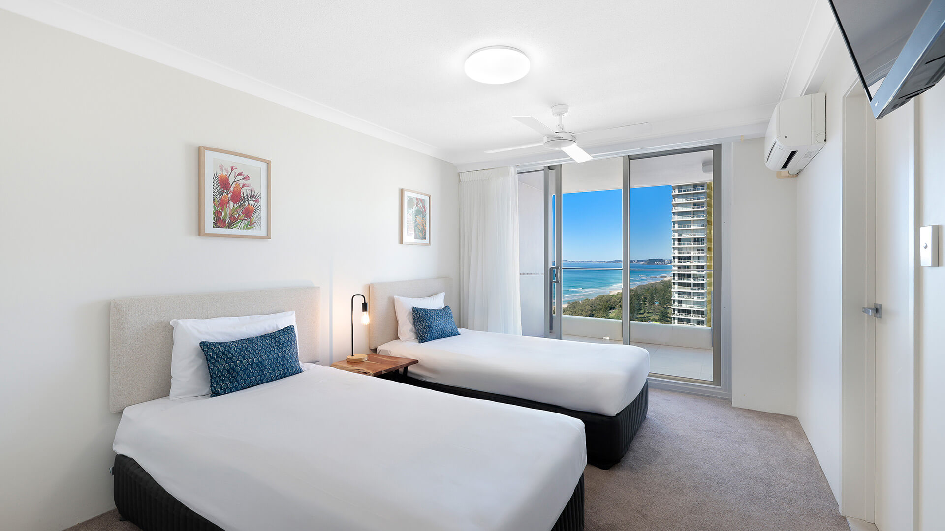Twin bedroom with balcony access and ocean views at ULTIQA Beach Haven on Broadbeach, Surfers Paradise, Gold Coast.