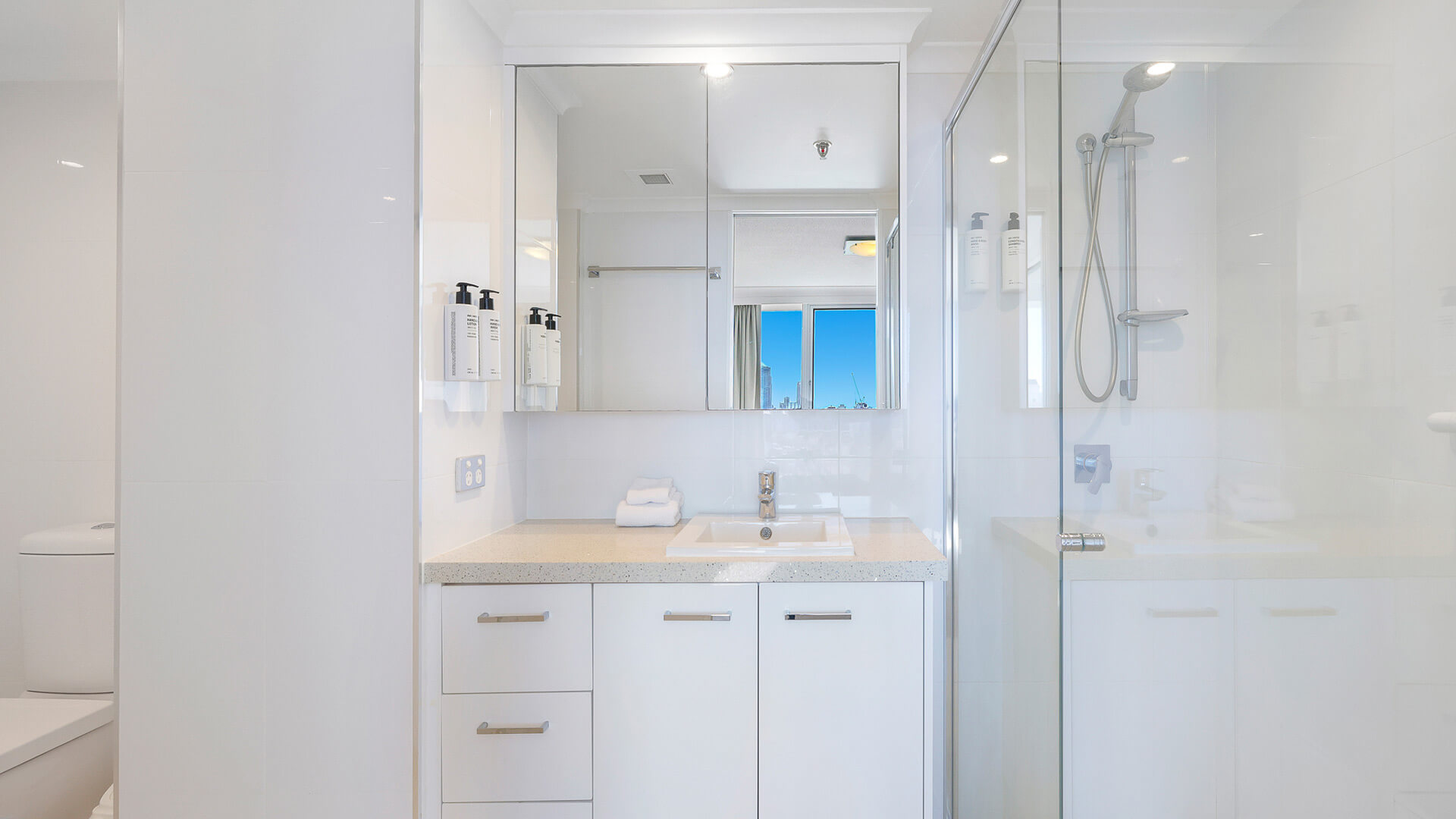 Bright ensuite in the Sub Penthouse at ULTIQA Beach Haven on Broadbeach, featuring a walk-in shower and large mirrored vanity.